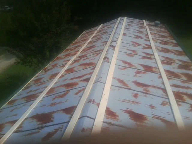 Rusted metal roof panels with new wood purlins before replacement — Storm Damage Roof Repair in Clearlake by Roofing Brothers