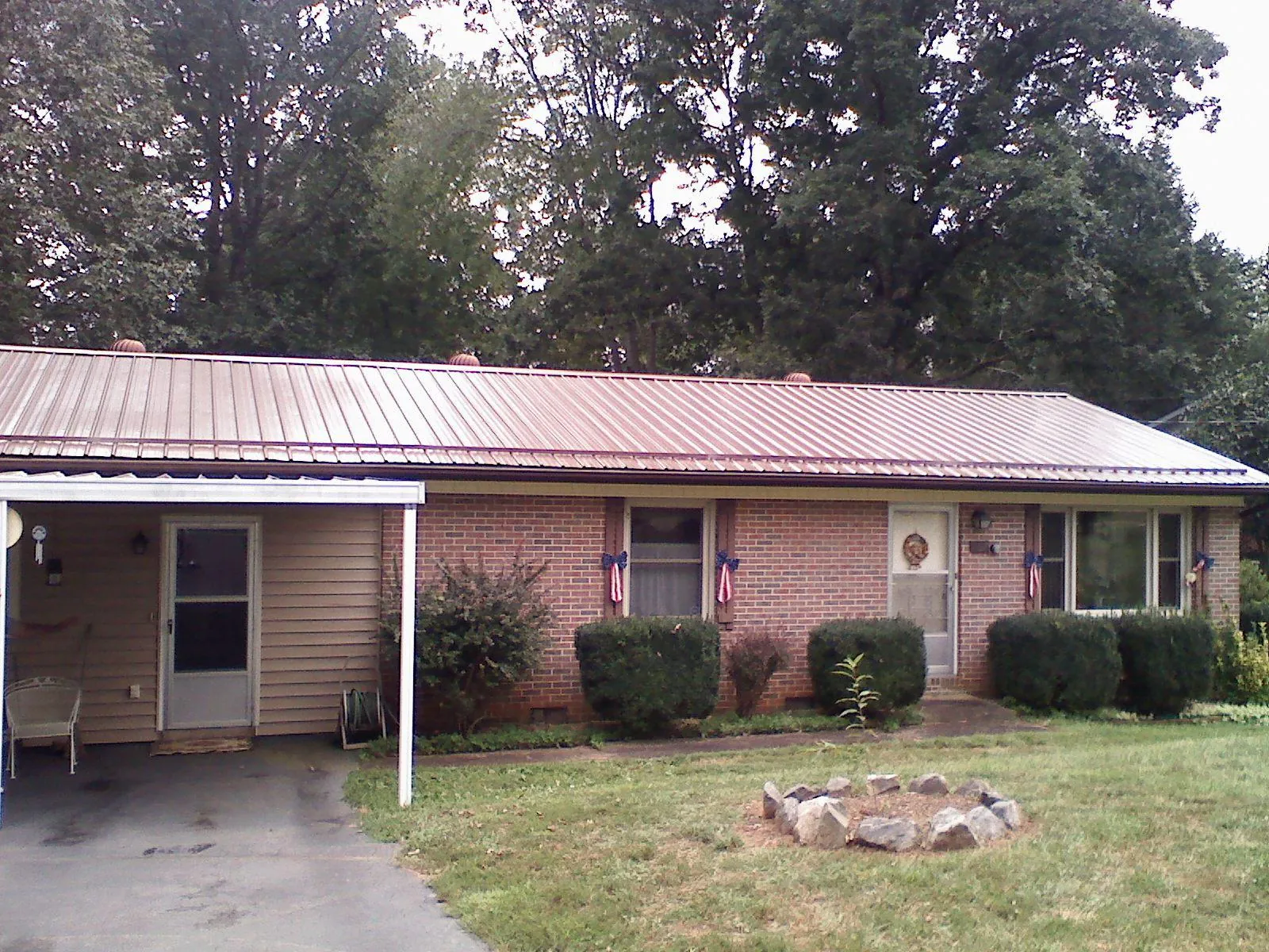 Bronze metal roof and carport on a brick ranch home — Roof Repair work by our crew in Clearlake